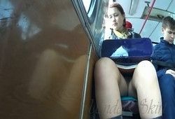 Парень в трамвае заглядывает девушке под юбку